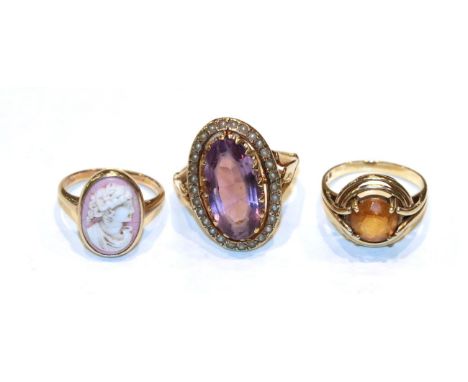 A cameo ring, unmarked, finger size K; a 9 carat gold amethyst and seed pearl ring, out of shape; and a dress ring, stamped '