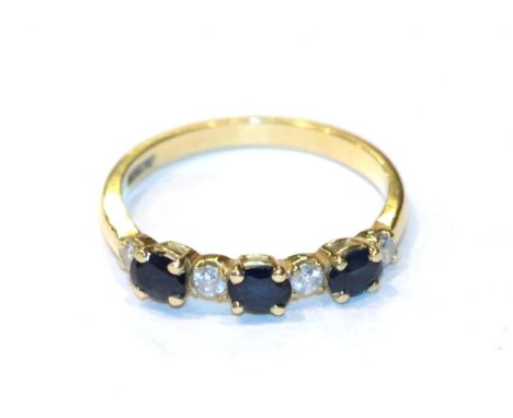 An 18 carat gold sapphire and diamond ring, finger size N.  Gross weight 2.3 grams. 