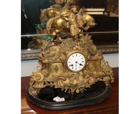 A French gilt metal striking mantel clock, the elaborate case surmounted by a gentleman leaning on his horse, dial signed Hat