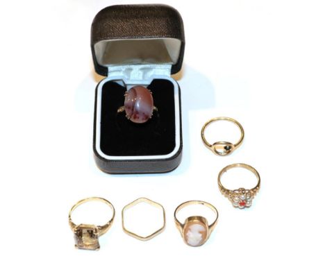 A cameo ring, stamped '9CT', finger size M; a 9 carat gold hexagonal shaped band ring; a 9 carat gold onyx ring, finger size 