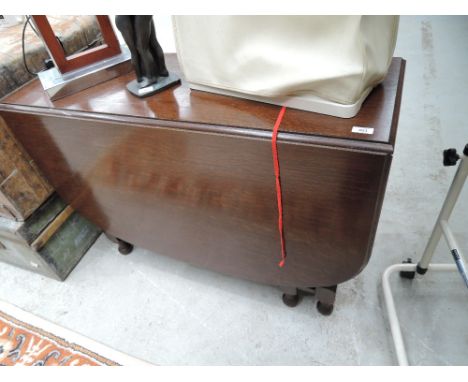 A mid 20th Century oak gate leg dining table