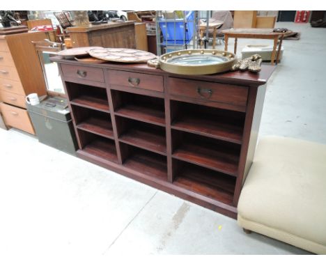 A hardwood shelf unit with frieze drawers