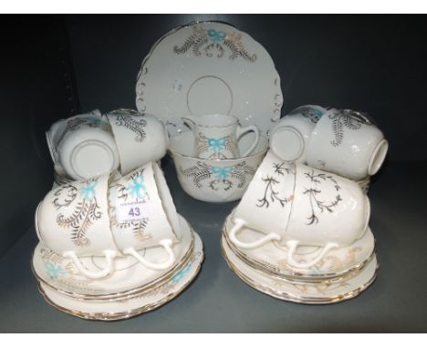 A part tea service with blue and gilt decoration