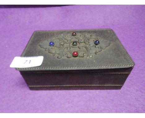 A hand worked trinket or jewellery box with decorative foliate work and beads