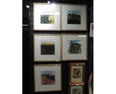 A selection of photographs in modern light oak frames 