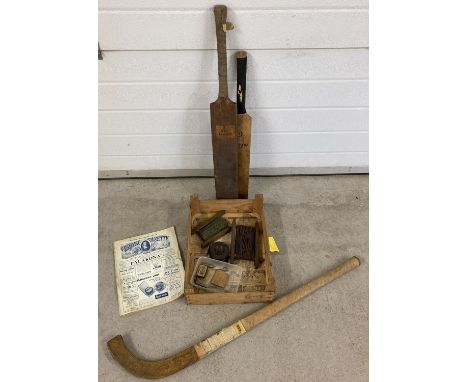 A small collection of vintage sporting related items. To include 2 cricket bats, a Hazell's Ltd, London Hockey stick and wood