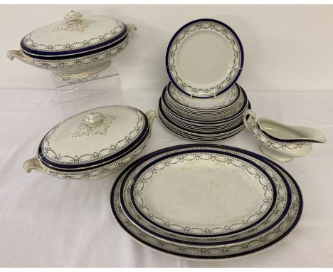 A quantity of Edwardian ceramic dinner ware with blue and gilt detail and floral swag design. Comprising: a set of 3 graduati