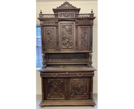 An early 20th century carved oak French dresser with 5 cupboards and 2 drawers. 2 drawer, 2 door cupboard base with interior 