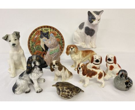 A collection of ceramic, resin and glass dog, cat and bird figurines. To include a pair of small Staffordshire dogs, a Cooper