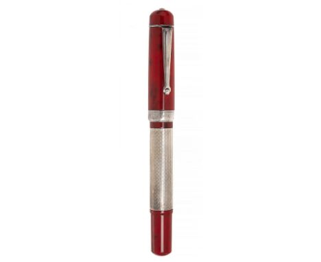 DELTA "NAITILUS" FOUNTAIN PEN.Red resin barrel and rhodium plated steel ornamentation and body.Limited edition.Nib in 18 kts 