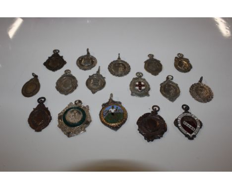 A box of various silver and other sporting fobs and medals 