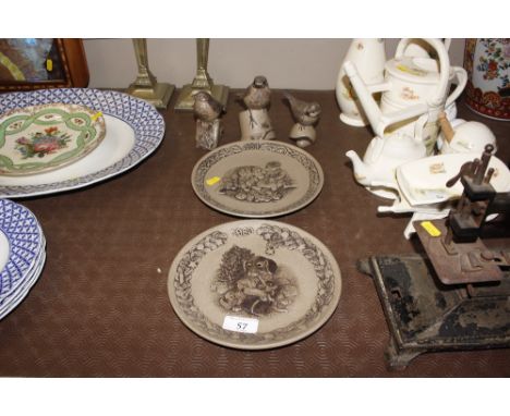 Three Poole bird ornaments together with two Poole plates