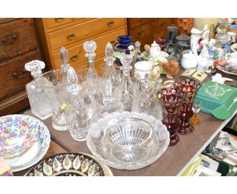 A quantity of various table glassware to include decanters and stoppers, ruby glass vases, glass jugs, etc.