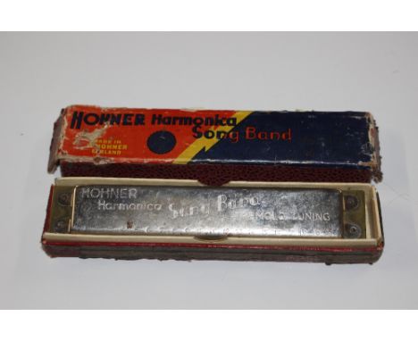 A Hohner harmonica in original box 