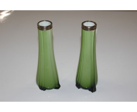 A pair of green opaque glass spill vases with silver mounts