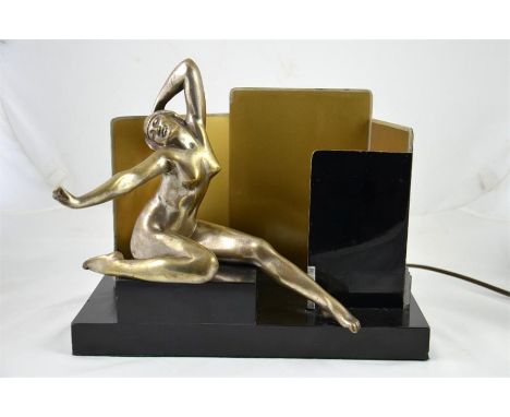 An art deco bronze lamp with a nude sat on onyx base. Signed Louis Florent. Height 26cm.