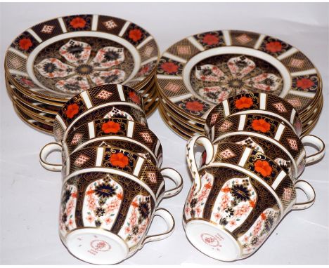 A set of six Royal Crown Derby 1128 pattern tea set, including six cups, six saucers, six side plates. One saucer and one cup