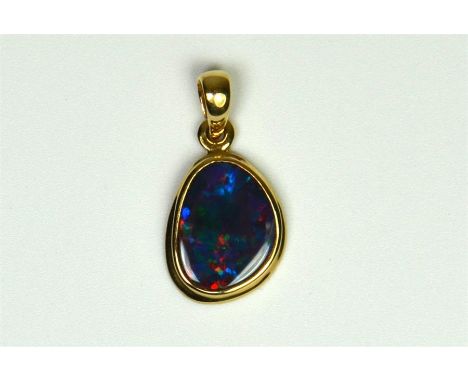 A 14ct yellow gold pendant, set with thought to be Lightening Ridge black opal, approx 18mm in length including loop.