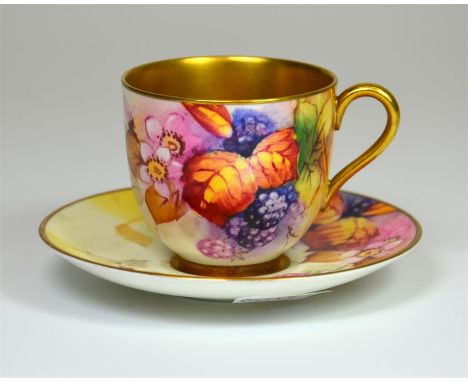 A Royal Worcester cup and saucer, with fruit decoration and gilded interior, signed M. Miller. Printed marks. Date code 1954.