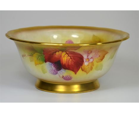 A Royal Worcester bowl on footed base, with gilded trim and fruit decoration to body, signed K. Blake. Printed marks. Date co