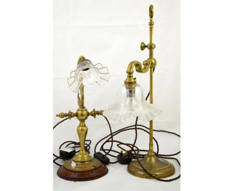 An early 20th century arts and crafts style brass desk lamp, also another early 20th century desk lamp. Height 49cm. (2)