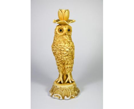 A Sitzendorf porcelain figure of an owl candlestick. Modelled with glass eyes. Circa 1890. Height 34cm.