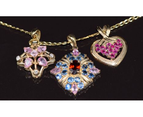 Three 9ct gold pendants one set with pink sapphires, topaz and paste, one with pink sapphires and diamonds and the other rubi