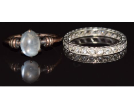 A 9ct white gold eternity ring set with spinel and a 9ct gold ring set with a moonstone, 3.5g, size I &amp; K