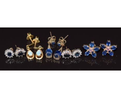 Five pairs of 9ct gold earrings set with sapphire cabochons, sapphire floral cluster, opal, sapphire surrounded by diamonds a