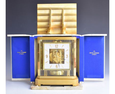 Jaeger Le Coultre Atmos clock, in gilt and glazed case, the white square with applied gilt numerals, in original box, togethe