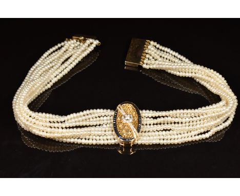 A nine strand pearl necklace with detachable 18ct gold pendant with pierced honeycomb decoration set with diamonds in a clust