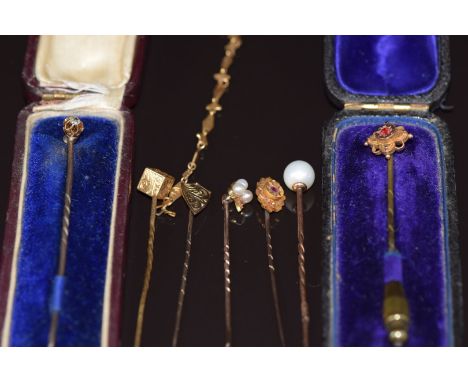 A collection of stick pins comprising&nbsp;9ct gold set with a diamond, another 9ct gold set with paste, a 15ct gold set with