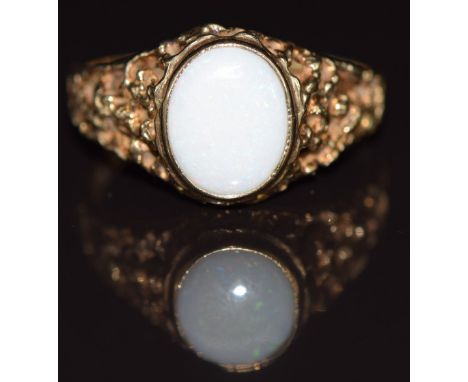 A 9ct gold ring set with a white opal, with pierced textured shoulders, 3g, size R