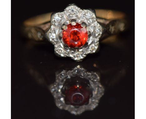A 9ct gold ring set with a garnet surrounded by diamonds in a cluster setting, 2g, size J