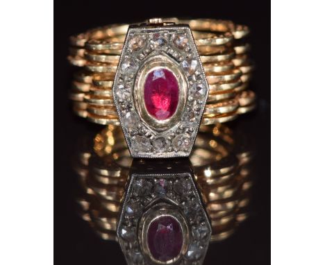 A 14ct gold metamorphic ring / bracelet set with an oval ruby of approximately 0.5ct surrounded by rose cut diamonds, 14.7g, 