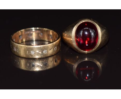 A 9ct gold ring set with a synthetic ruby cabochon and a 9ct gold eternity ring, 5g, size J &amp; G