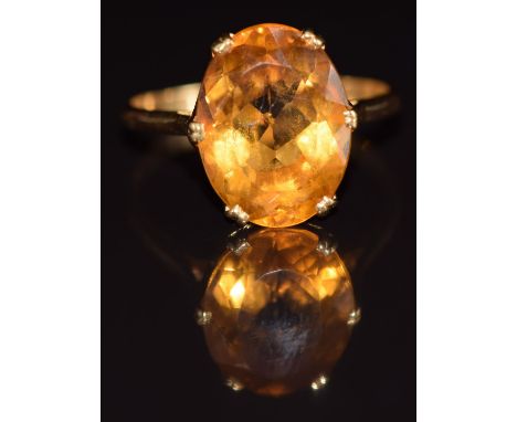 An 18ct gold ring set with an oval cut citrine, 4.9g, size S