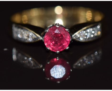 An 18ct gold ring set with a round cut ruby and diamonds, 3g, size N