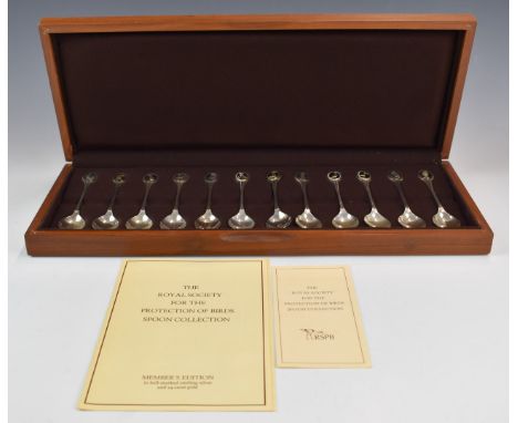 Cased set of 12 hallmarked silver RSPB spoons with gilt portrait of a bird to top of each, London 1975, maker John Pinches (M