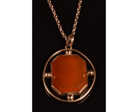 A 9ct rose gold pendant set with carnelian agate (6g) on a 9ct rose gold chain made up of faceted and oval links (5.2g)