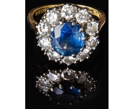 An 18ct gold ring set with a sapphire of approximately 1.5ct&nbsp;surrounded by ten diamonds, each measuring approximately 0.