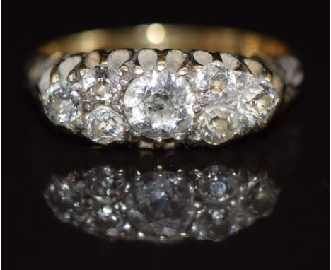 An 18ct gold ring set with seven diamonds, the largest approximately 0.4ct, 3g, size K