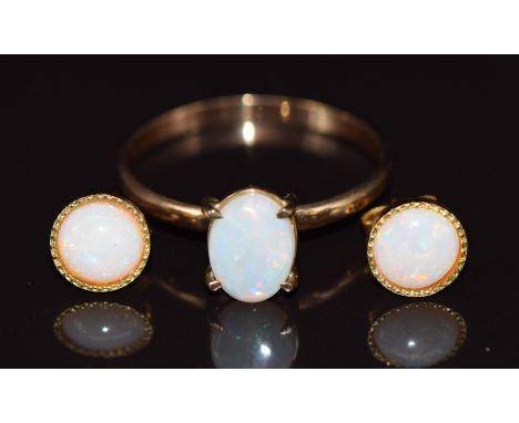 A 9ct gold ring set with an opal (1.1g, size P) and a pair of silver gilt earrings set with an opal&nbsp;