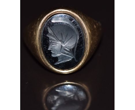 A 9ct gold ring set with a hematite intaglio, 7.4g, size R