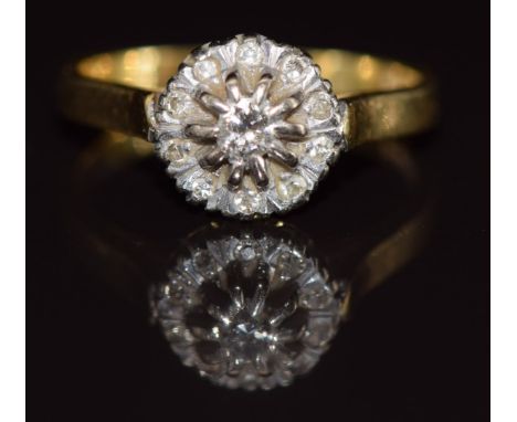 An 18ct gold ring set with diamonds in a cluster, 4.1g, size M