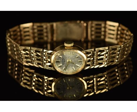 Rotary 9ct gold ladies wristwatch with two-tone hands and hour markers, silver dial and mechanical movement, on integral 9ct 