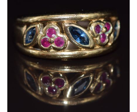 A 9ct gold ring set with round cut rubies and marquise cut sapphires in a floral design, 5g, size L