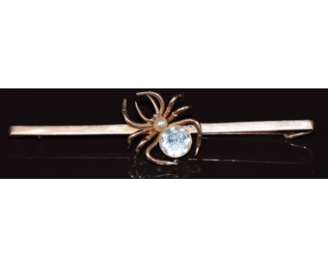 A 9ct gold bar brooch in the form of a spider set with a round cut aquamarine and pearl, in Mikara Pearl Company, 48 Piccadil