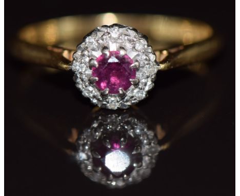 An 18ct gold ring set with a ruby surrounded by diamonds, 3.1g, size P