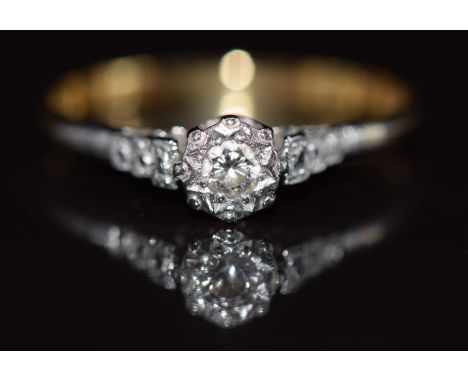 An 18ct gold ring set with a diamond in a platinum setting, 2.2g, size R